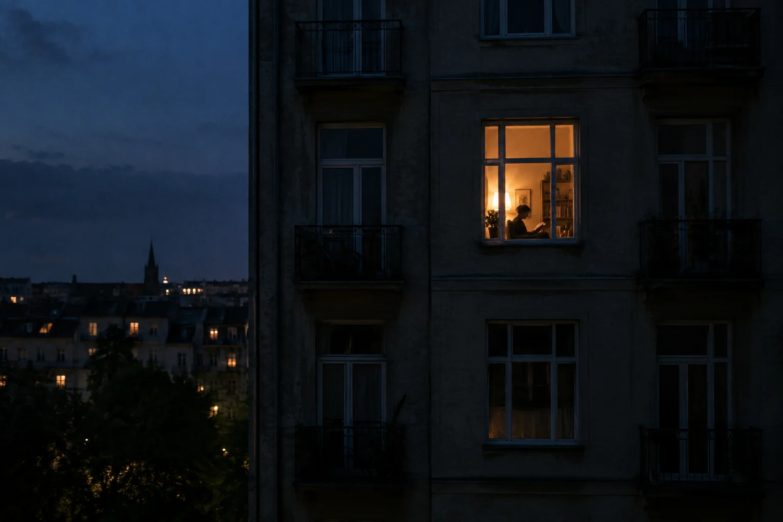 Dark apartment facade at blue hour with one warmly lit window and a subtle adult silhouette reading, quiet distant framing, available light only.